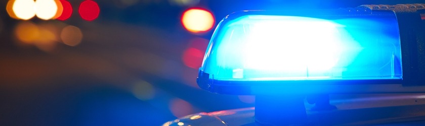 Close-up shot of a highway patrol car's blue emergency vehicle lighting